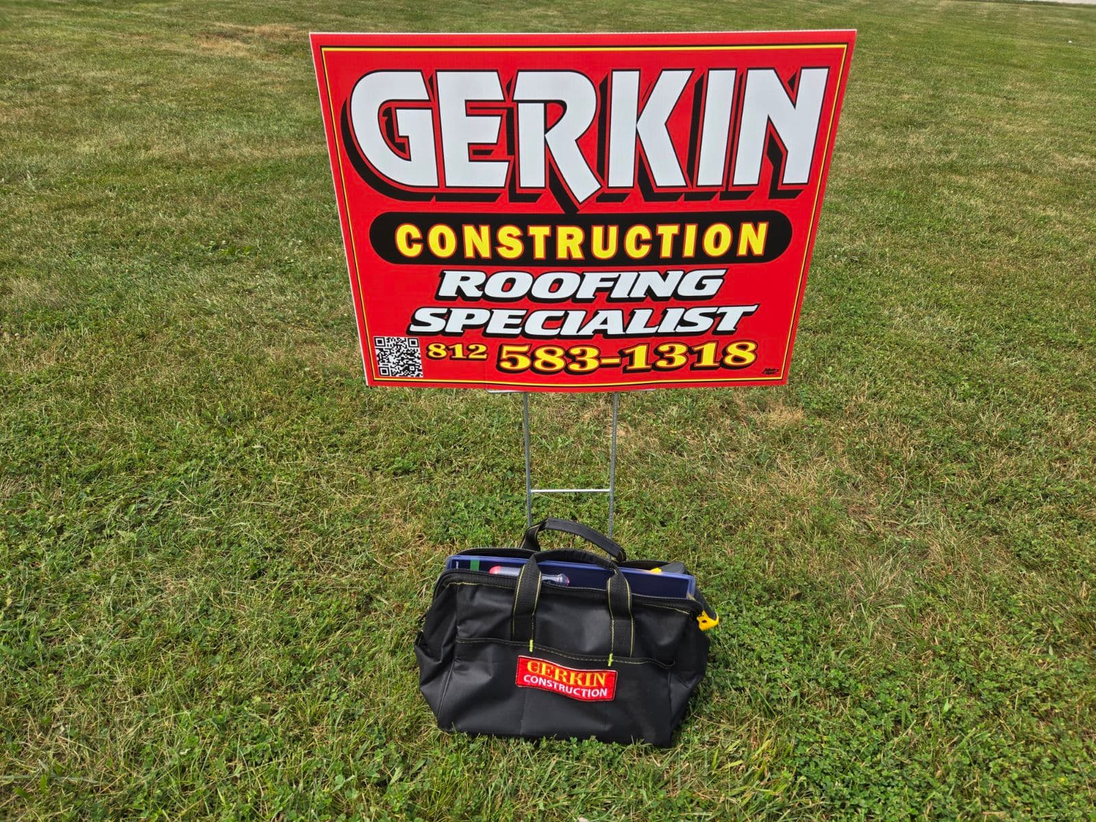 A Gerkin Construction yard sign in a front yard with the prize tool bag under it